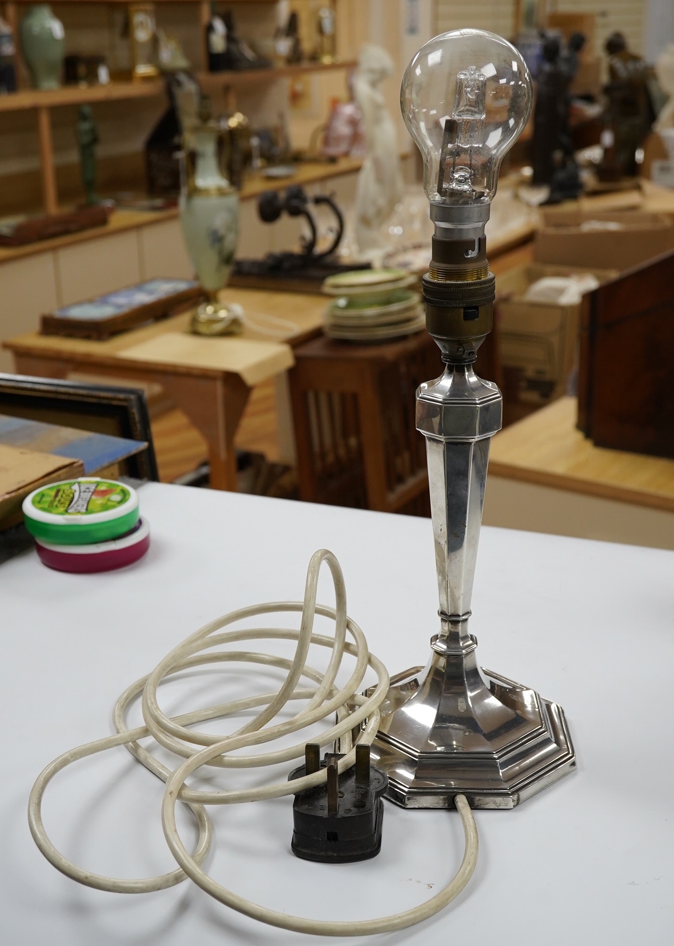 A George V silver octagonal electric lamp base, by Mappin & Webb, London, 1934, with engraved dates, overall 34.2cm. Condition - fair